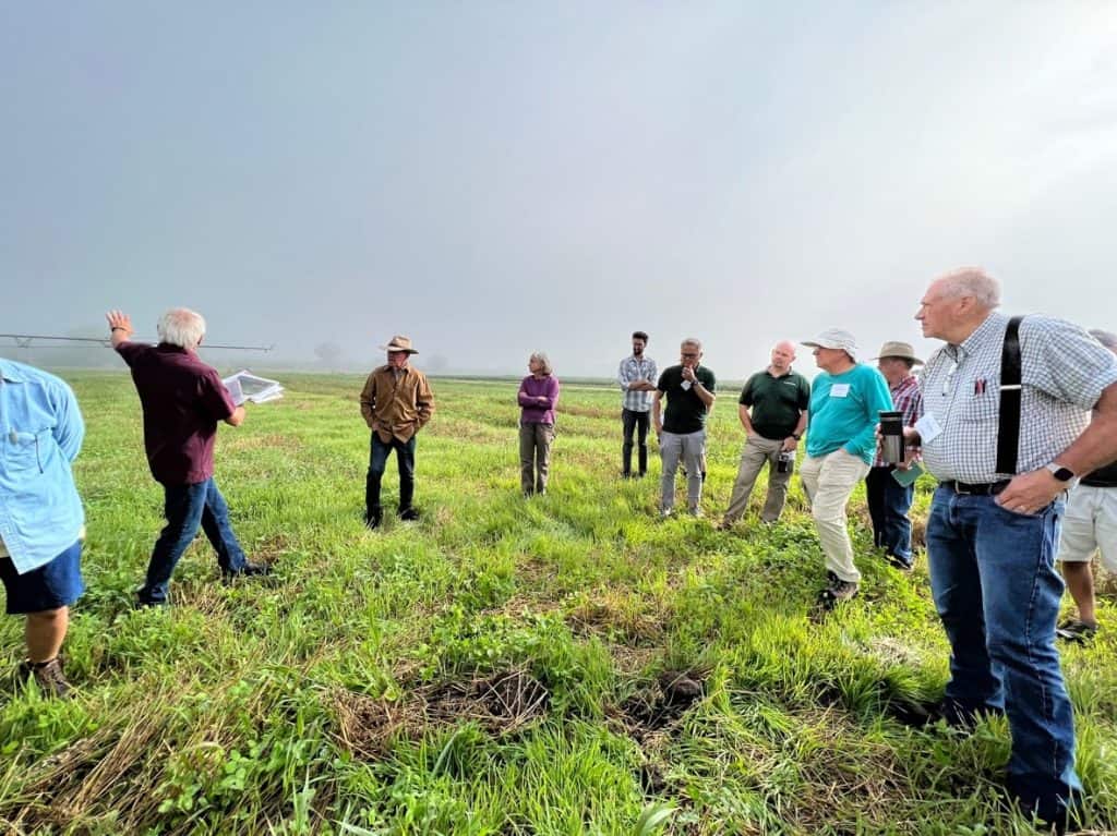 Group stands in field